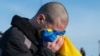 A Ukrainian POW reacts after being swapped in a prisoner exchange with Russia on January 31. 
