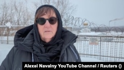 Lyudmila Navalnaya, the mother of late Russian opposition leader Alexei Navalny, delivers a video address to Russian President Vladimir Putin as she stands near the Arctic Polar Wolf prison on February 20.