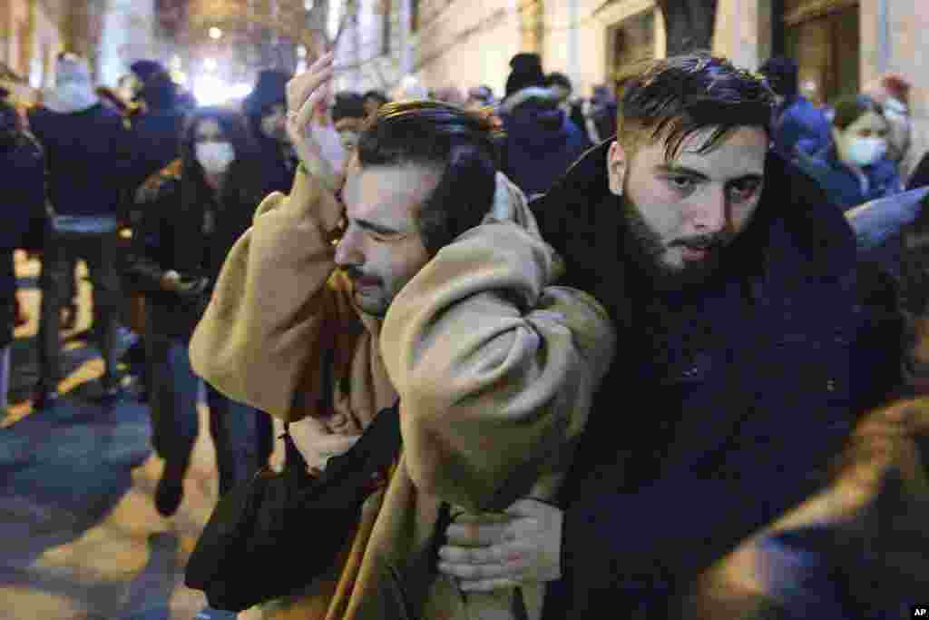 A protester wipes his eyes after tear gas was fired at protesters. 