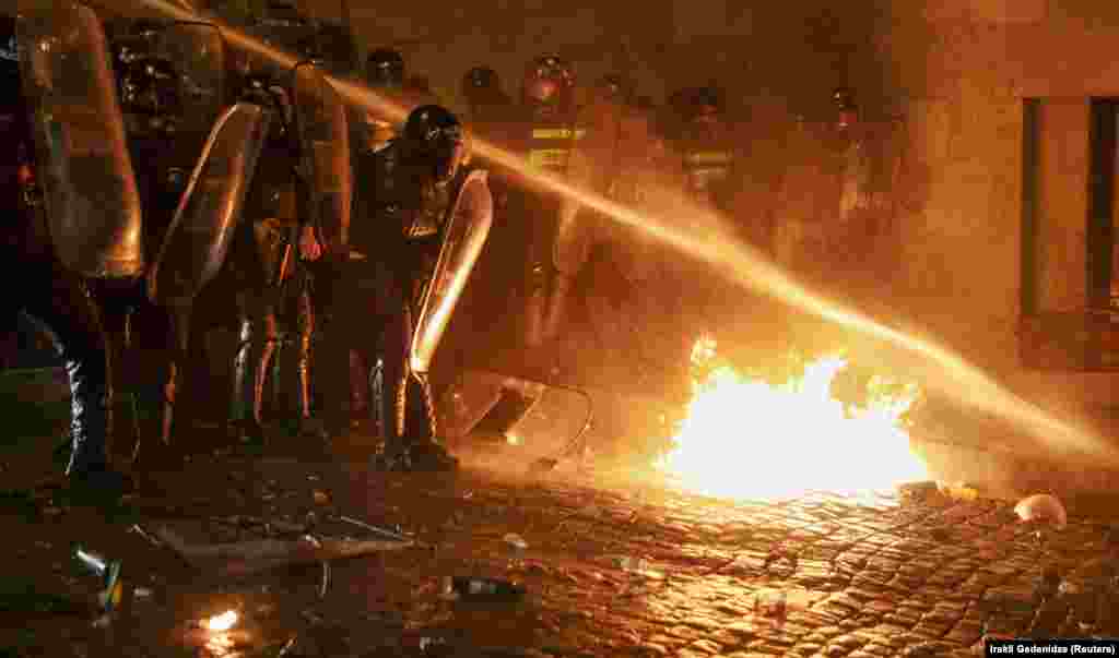A fire is extinguished by a water cannon. 