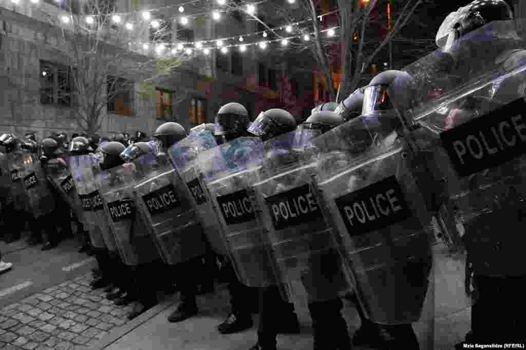 Riot police line up to force protesters away from the parliament. 