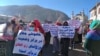 A group of veiled Afghan women marched through Kabul, carrying banners with slogans demanding rights, on November 24.

