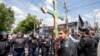An Orthodox believer with a cross takes part in a protest against a rally organized by the LGBT community for human rights and equality in Chisinau on May 21.
