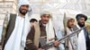 Surrendering Taliban militants hand over their weapons in Herat.