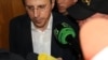 Chisinau Mayor Dorin Chirtoaca is escorted by anticorruption officers in Chisinau on May 25.