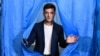 UKRAINE -- Ukrainian comedian and presidential candidate Volodymyr Zelensky walks out of a voting booth at a polling station during the second round of Ukraine's presidential election in Kyiv on April 21, 2019.