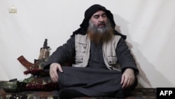 Abu Bakr al-Baghdadi as he appeared in a video released in April 
