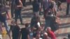 WATCH: A man throwing what appeared to be a grenade during a protest in Kyiv was caught on video by Radio Free Europe/Radio Liberty cameras. The violence erupted after parliament approved a draft constitutional amendment granting more autonomy to the eastern Ukrainian regions. (RFE/RL's Ukrainian Service)