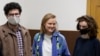 Doxa magazine editors Armen Aramyan (left to right), Natalya Tyshkevich, and Alla Gutnikova wait for a court session in Moscow in April 2021.