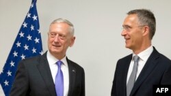 U.S. Secretary for Defense Jim Mattis (L) speaks with NATO Secretary-General Jens Stoltenberg prior to a meeting at NATO headquarters in Brussels on June 29.