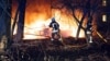 Firefighters work at the site of a residential area hit by a Russian missile strike in Sumy on November 17.