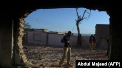 A policeman stands guard at the burnt Hindu temple a day after a mob attack in a remote village in the northwestern Karak district on December 31. (file photo)