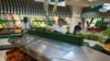 Olga Osypova, a 65-year-old Moscow pensioner, shops in a Moscow market, with empty shelves that would normally hold European vegetables.
