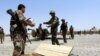 FILE: Members of the Afghan security forces take their positions during an operation against the Taliban in southern Afghanistan.