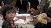 Afghanistan - Afghan refugees have meals at United Nation High Commissioner for Refugees (UNHCR) camp in Herat city, 31Oct2007