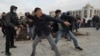 Supporters of Sadyr Japarov throw clumps of dirt toward supporters of former Kyrgyz President Almazbek Atambayev as they attend a rally in Bishkek on October 9.