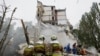 Rescuers clear debris at a Kyiv apartment building hit by Russian air attack on July 31, 2025