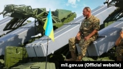 Український воїн-артилерист і зенітно-ракетні комплекси Оса-АКМ. Місто Чугуїв, Харківщина (архівне фото)
