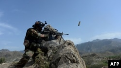 An Afghan security force personnel fires during an ongoing an operation against Islamic State (IS) militants in the Achin district of Nangarhar Province in April.