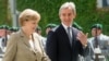 German Chancellor Angela Merkel (left) walks with Moldovan Prime Minister Iurie Leanca during a welcoming ceremony in Berlin on July 10.