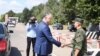 Moldovan President Igor Dodon (left) shakes hands with a Russian soldier at the peacekeeping post in Varniţa.